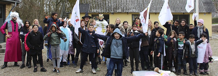 Et gruppebillede af børnene og de frivillige iført udklædningstøj